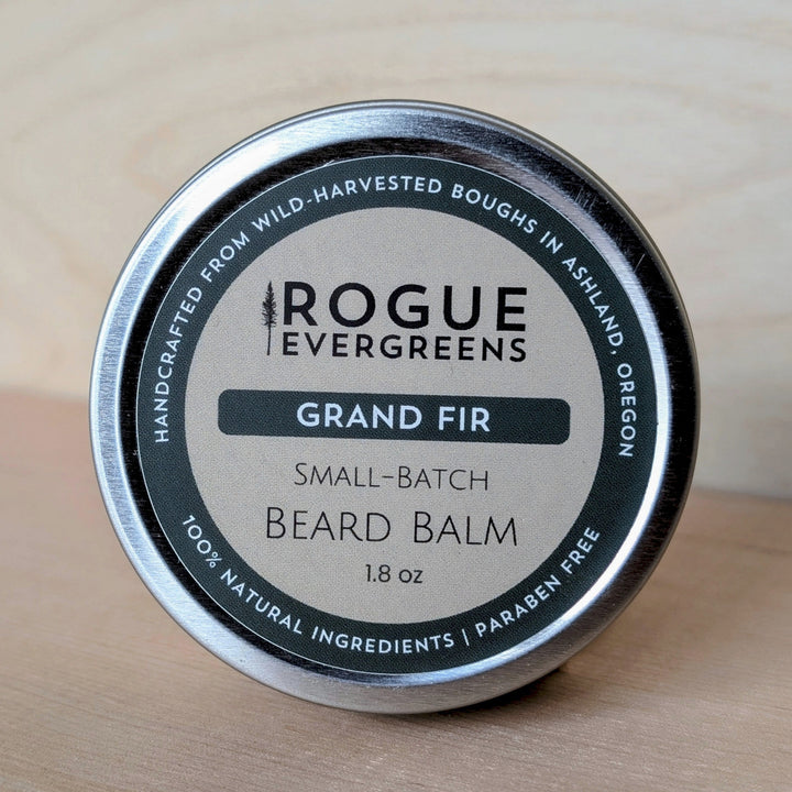 Tin of Rogue Evergreens Grand Fir beard balm on a wooden surface