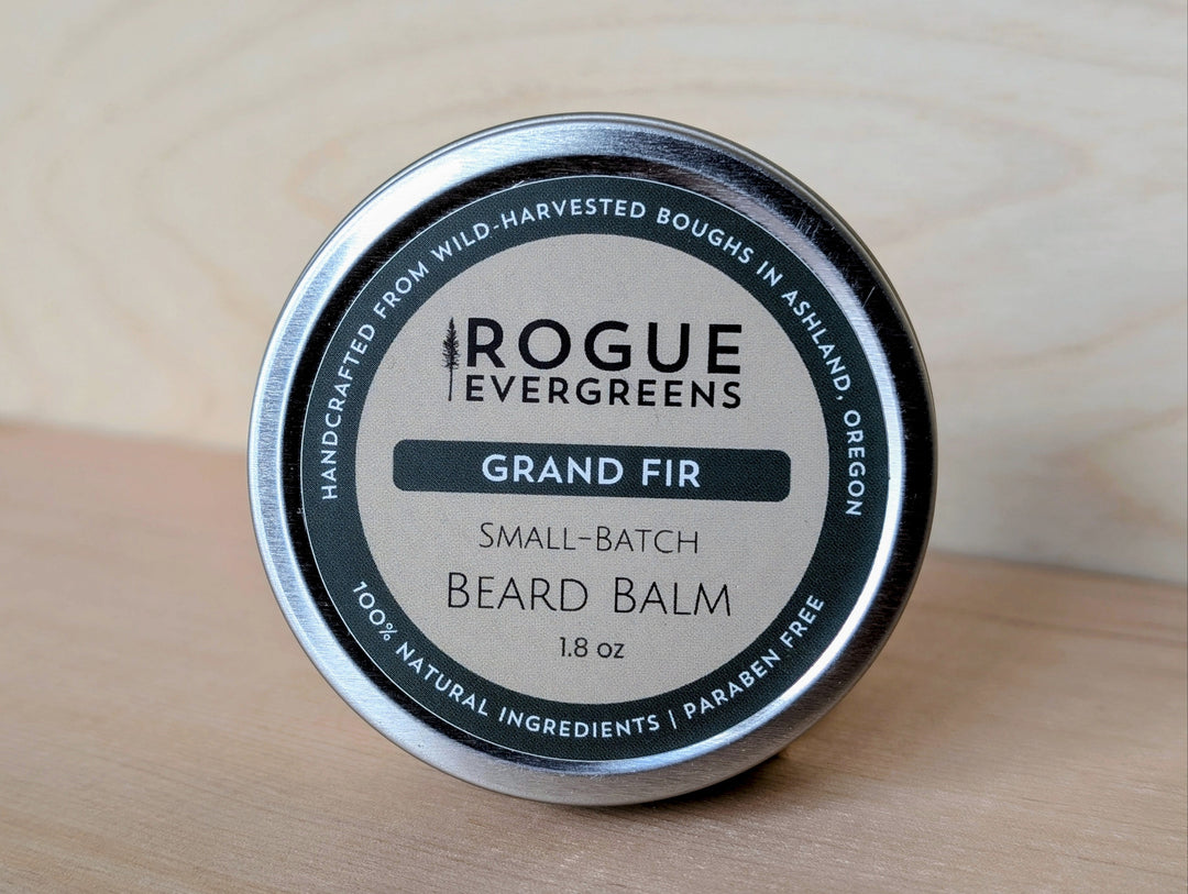 Tin of Rogue Evergreens Grand Fir beard balm on a wooden surface