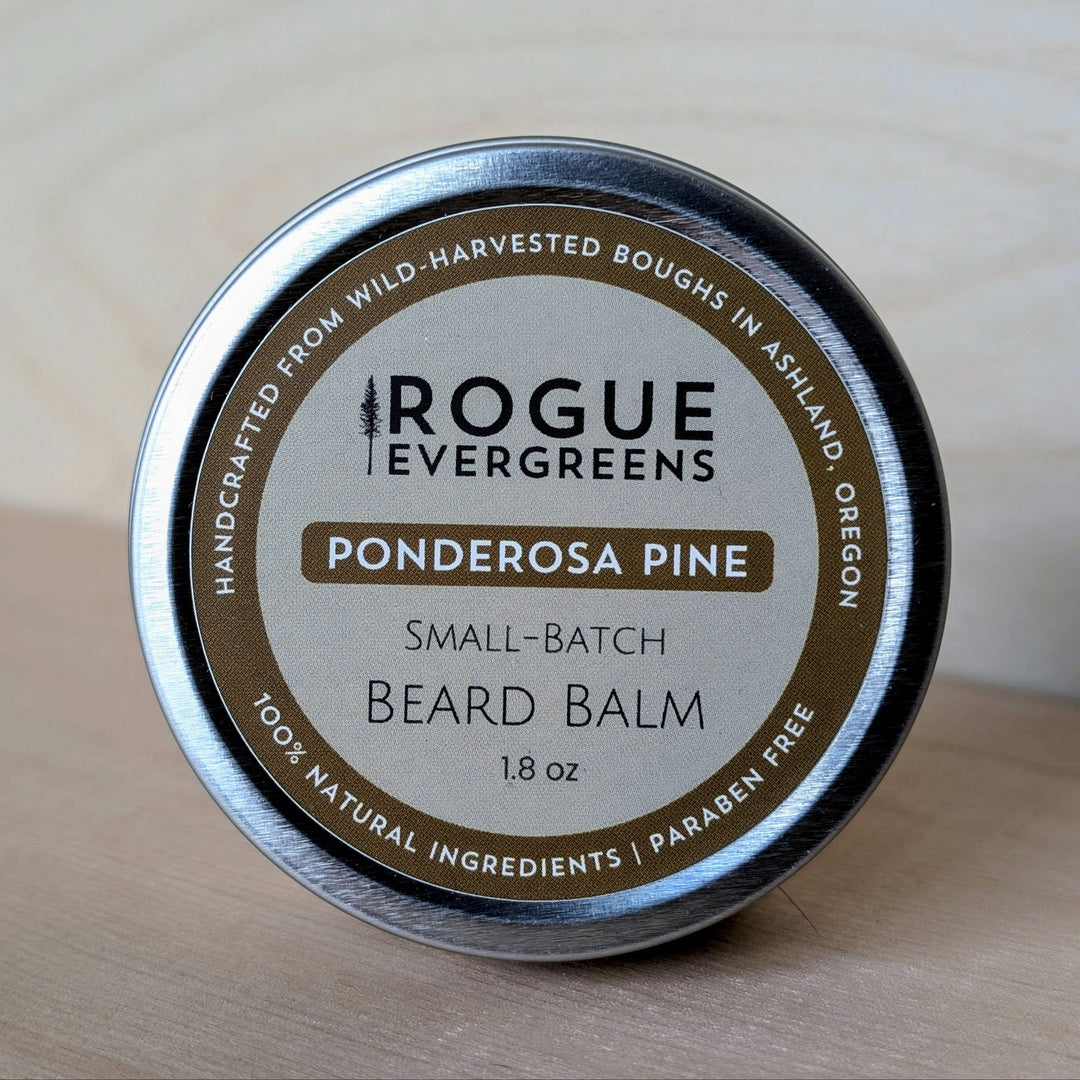 Tin of Rogue Evergreens Ponderosa Pine Beard Balm on a wooden surface